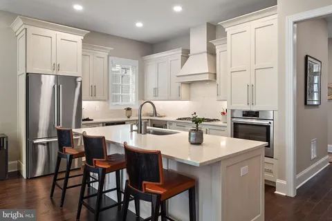 a kitchen with stainless steel appliances granite countertop a stove a refrigerator and a refrigerator