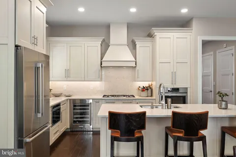 a kitchen with a sink stove top oven and refrigerator