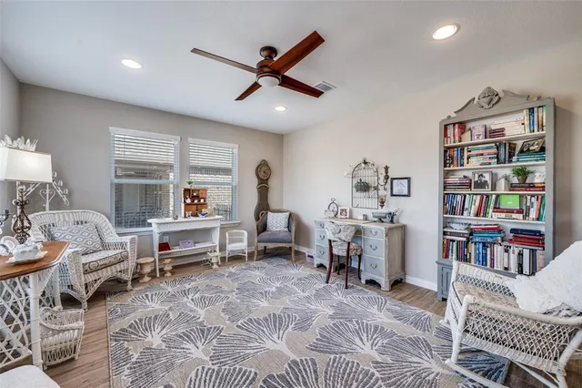 a living room with furniture a rug and a book shelf