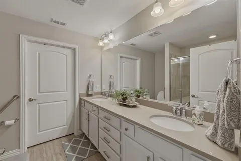 a spacious bathroom with a double vanity sink double and mirror