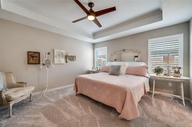 a bedroom with a bed a chair and a large window