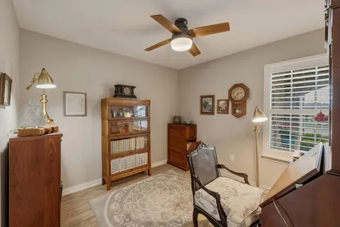 a view of a livingroom with furniture and a ceiling fan