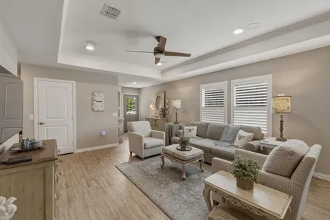 a living room with furniture and wooden floor