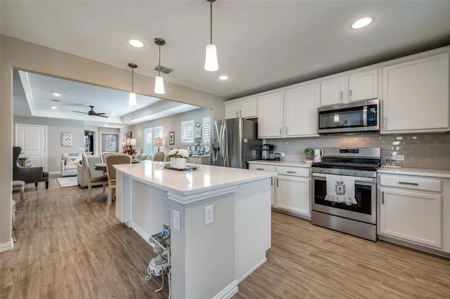 a kitchen with counter top space a sink appliances and cabinets