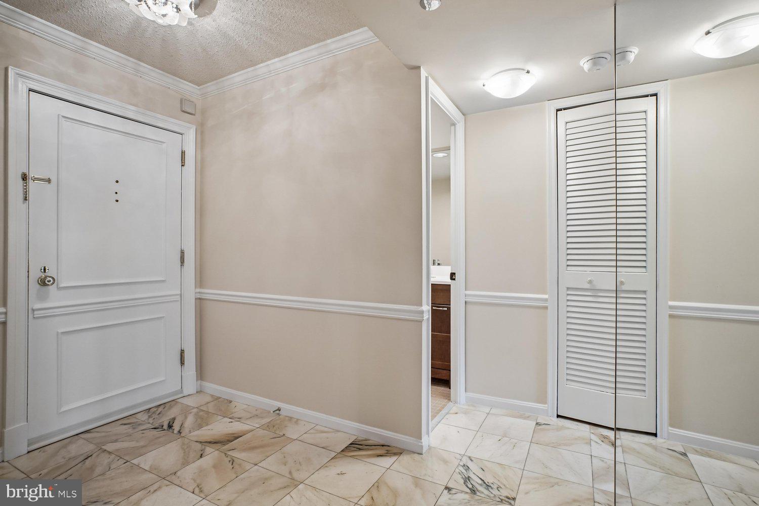 1301 North Courthouse Road, Unit 1612 Arlington, VA 22201 - Photo 4 of 52 Foyer & Louvred Door w/Washer & Dryer
