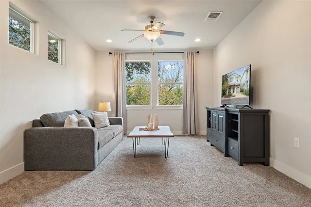 a living room with furniture and a large window