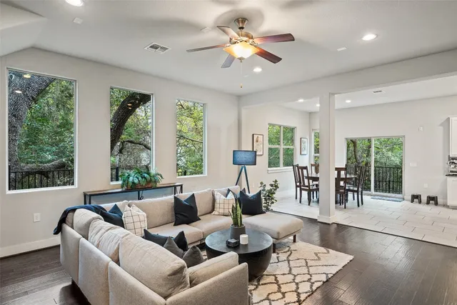 a living room with furniture and large windows