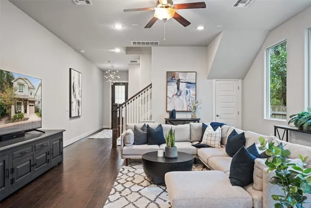 a living room with furniture and wooden floor