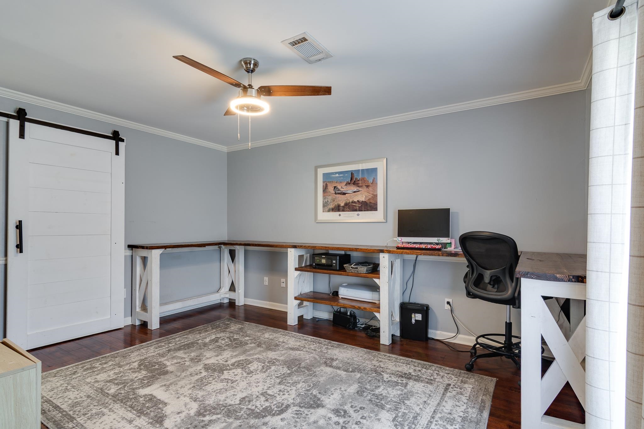 608 King Ridge Cove Collierville, TN 38017 - Photo 15 of 29 Versatile home office featuring built-in shelving and storage cabinetry with wood-finish countertops, hardwood flooring, ceiling fan with integrated lighting, and abundant natural light from dual windows