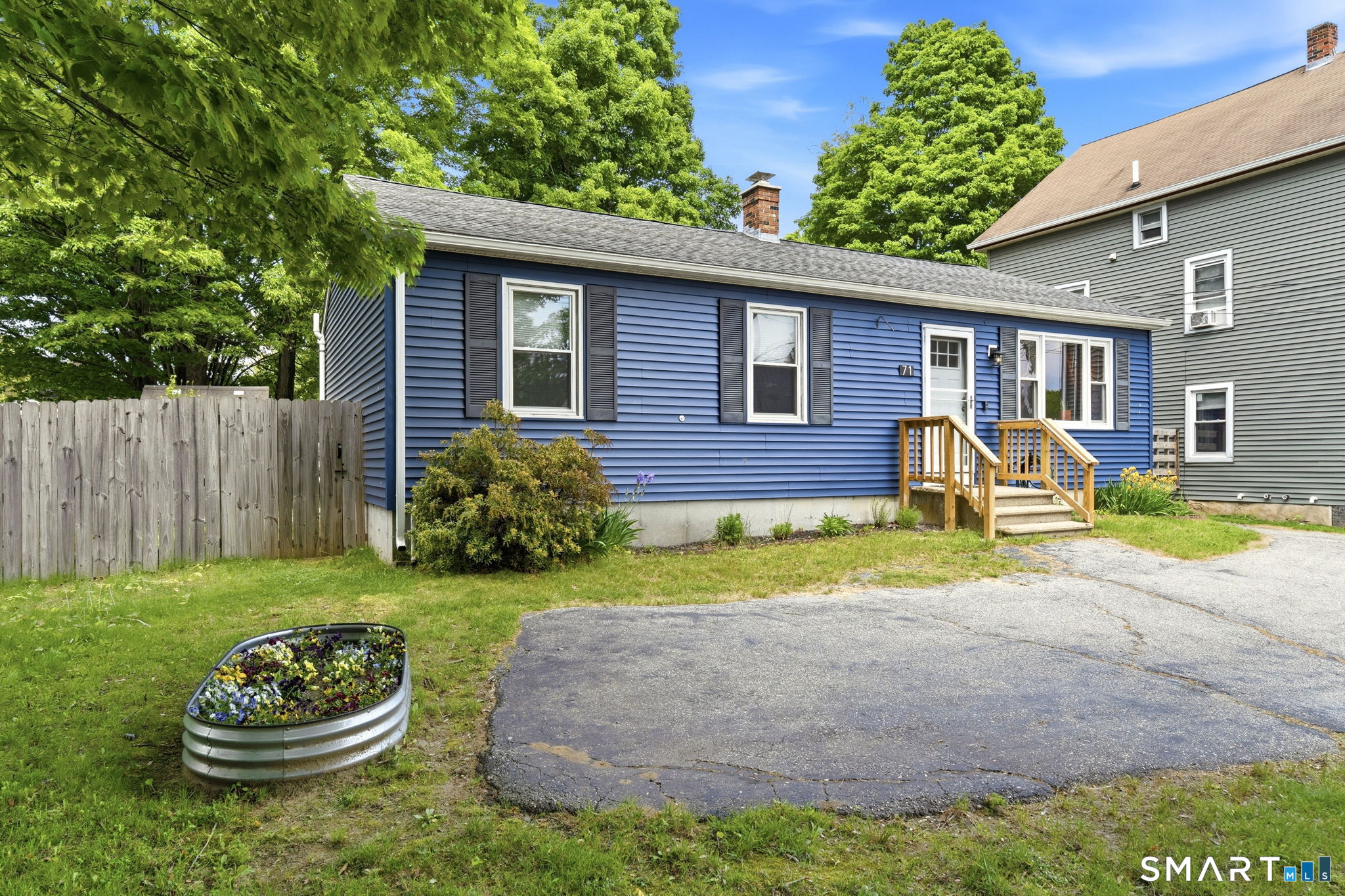 71 Smith Street Putnam, CT 06260 - Photo 24 of 25 a front view of a house with a yard and outdoor seating
