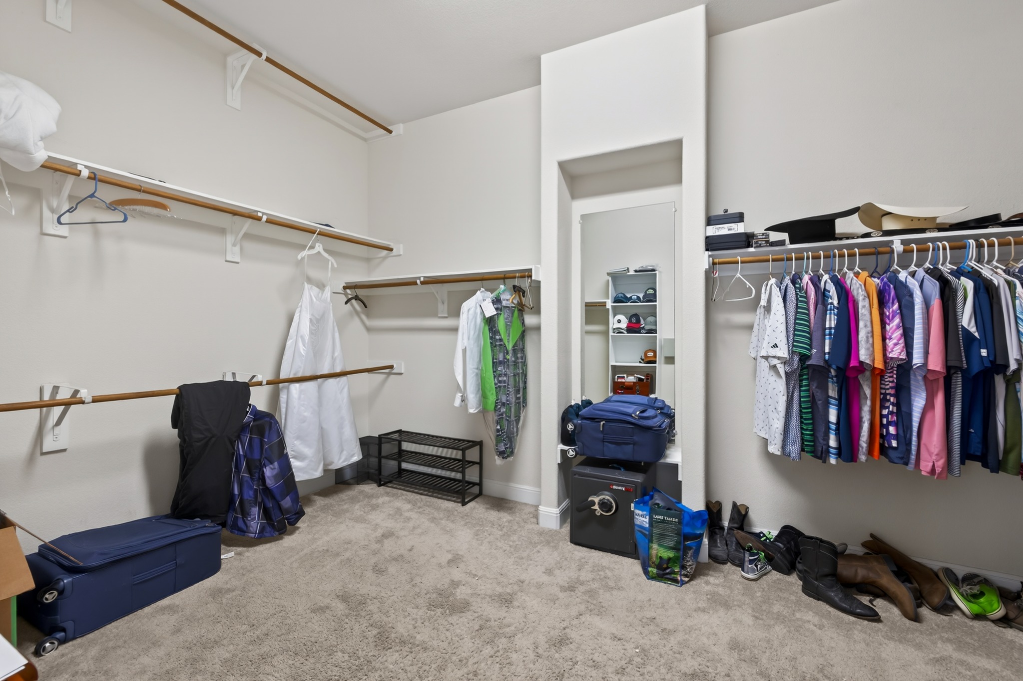 1017 Tabernash Leander, TX 78641 - Photo 25 of 38 Spacious walk-in closet featuring light-toned walls, carpeting, and multiple wood-finish hanging rods