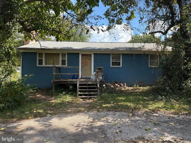 a backyard of a house with yard and outdoor seating