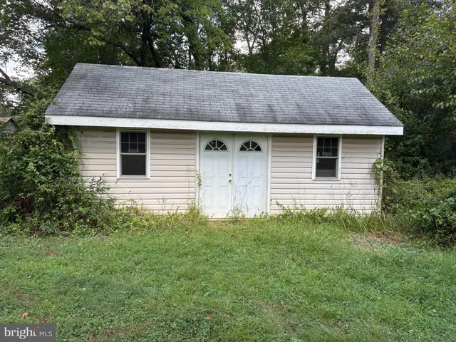 a view of barn house with a yard and large tree