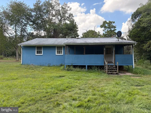 a brick house with a yard and garage