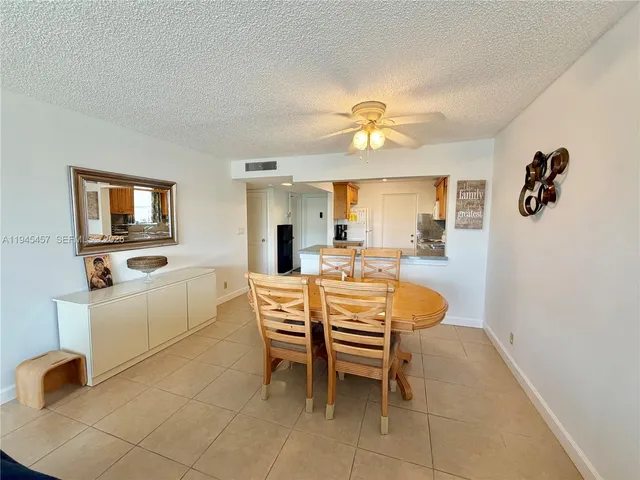 a view of a dining room with furniture and a chandelier