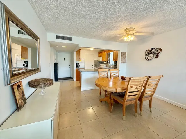 a dining room with furniture and a view of kitchen