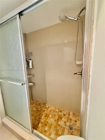 a bathroom with a toilet and a shower