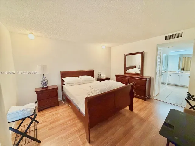 a view of a room with a window and wooden floor