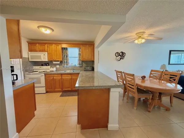 a kitchen with a stove a sink a counter top space and appliances