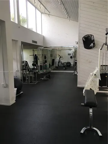 a room with gym equipment and windows
