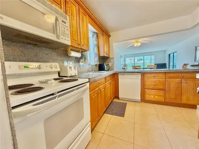 a kitchen with stainless steel appliances granite countertop a stove and a sink