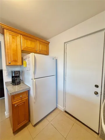 a white refrigerator freezer and a stove in a kitchen