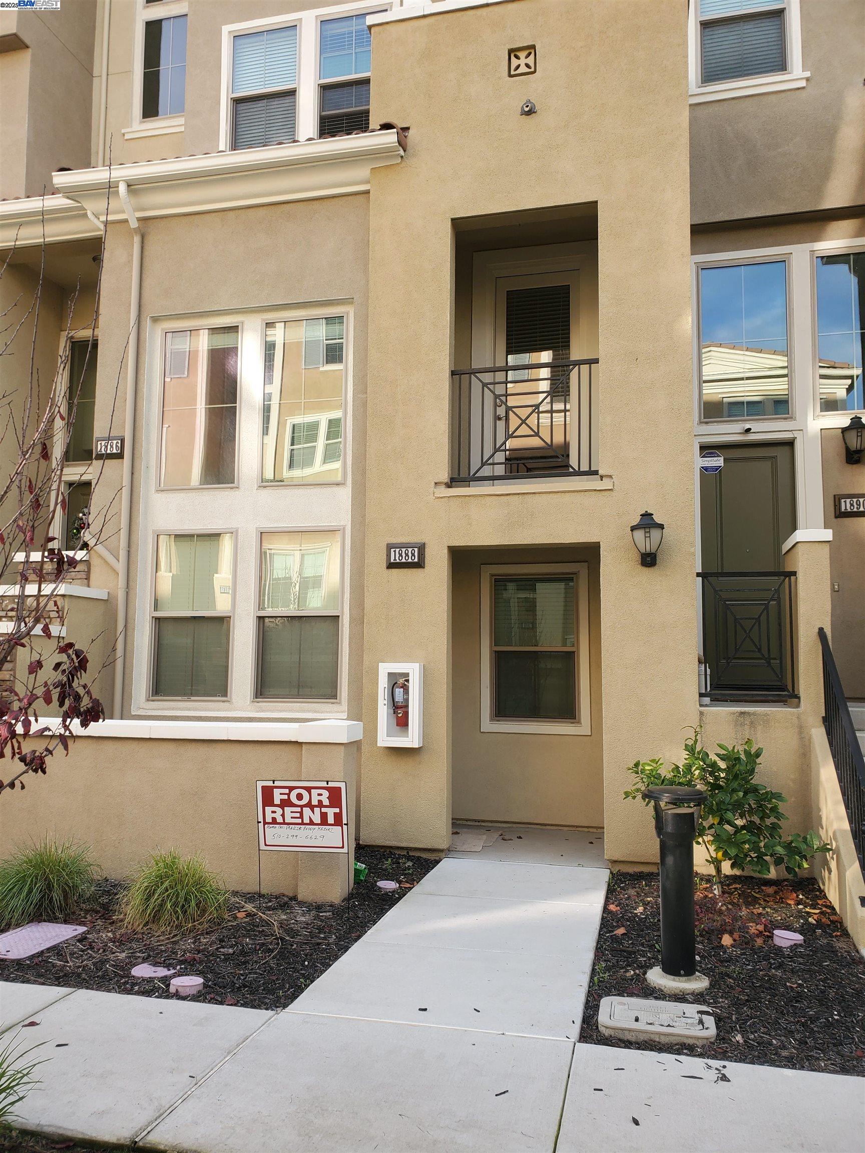 front view of a brick house with a small yard