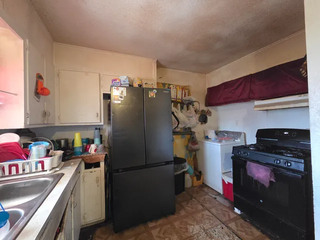 a kitchen with a refrigerator and a stove