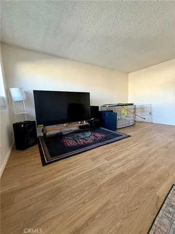 a living room with furniture flat screen tv and a table