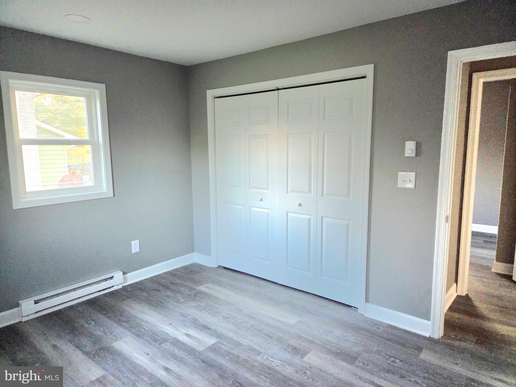 105 Goodwill Avenue Secretary, MD 21664 - Photo 17 of 24 an empty room with wooden floor and windows