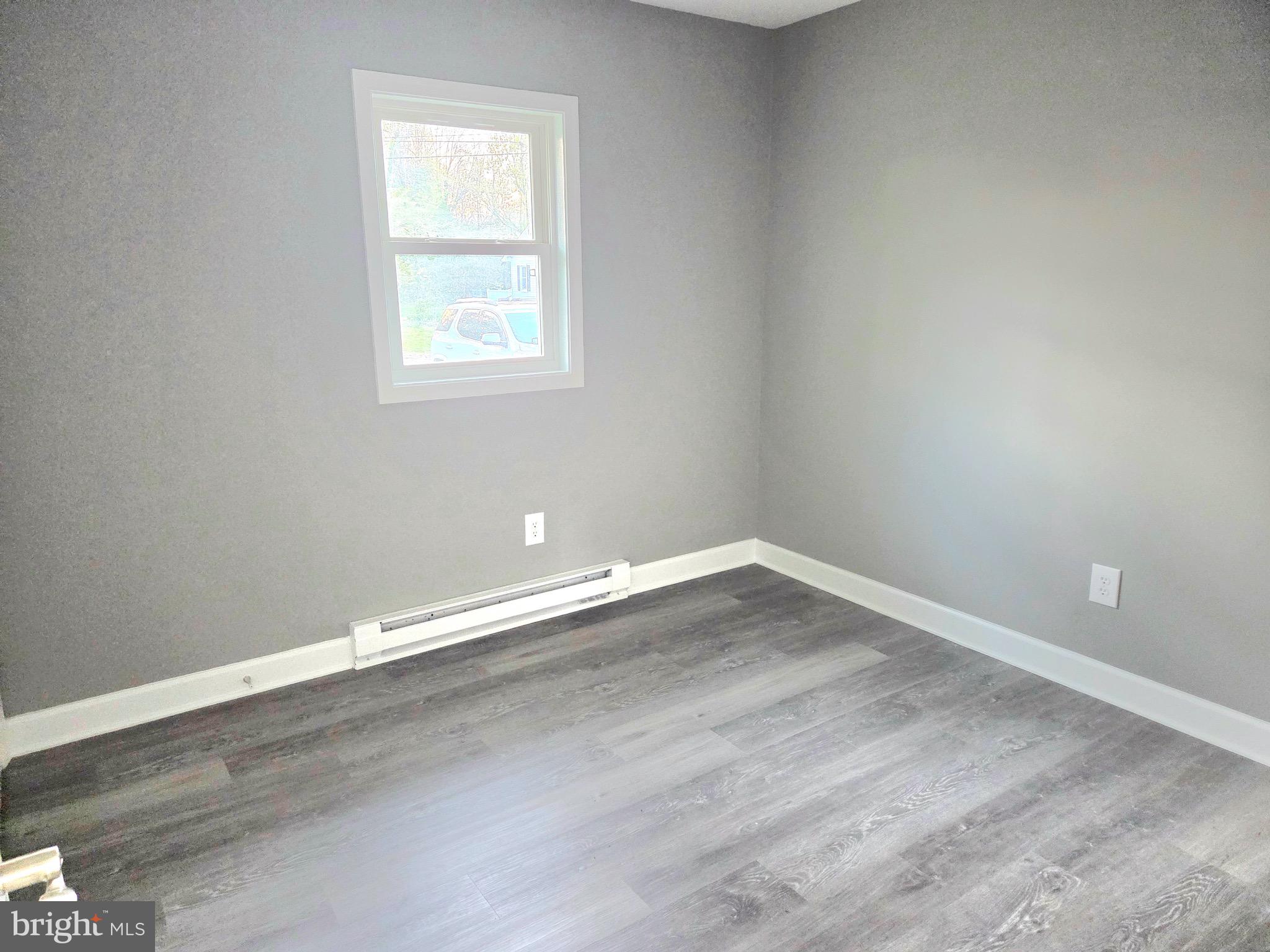 105 Goodwill Avenue Secretary, MD 21664 - Photo 19 of 24 an empty room with wooden floor and windows
