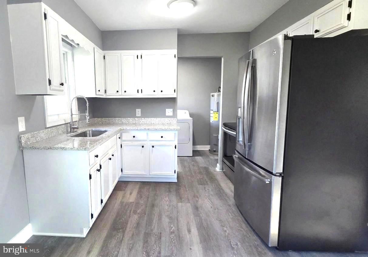 105 Goodwill Avenue Secretary, MD 21664 - Photo 7 of 24 a kitchen with stainless steel appliances a refrigerator sink and cabinets