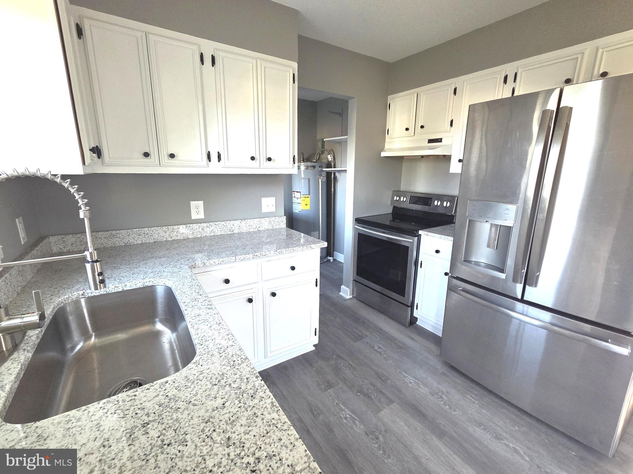 105 Goodwill Avenue Secretary, MD 21664 - Photo 8 of 24 a kitchen with stainless steel appliances granite countertop a refrigerator sink and stove