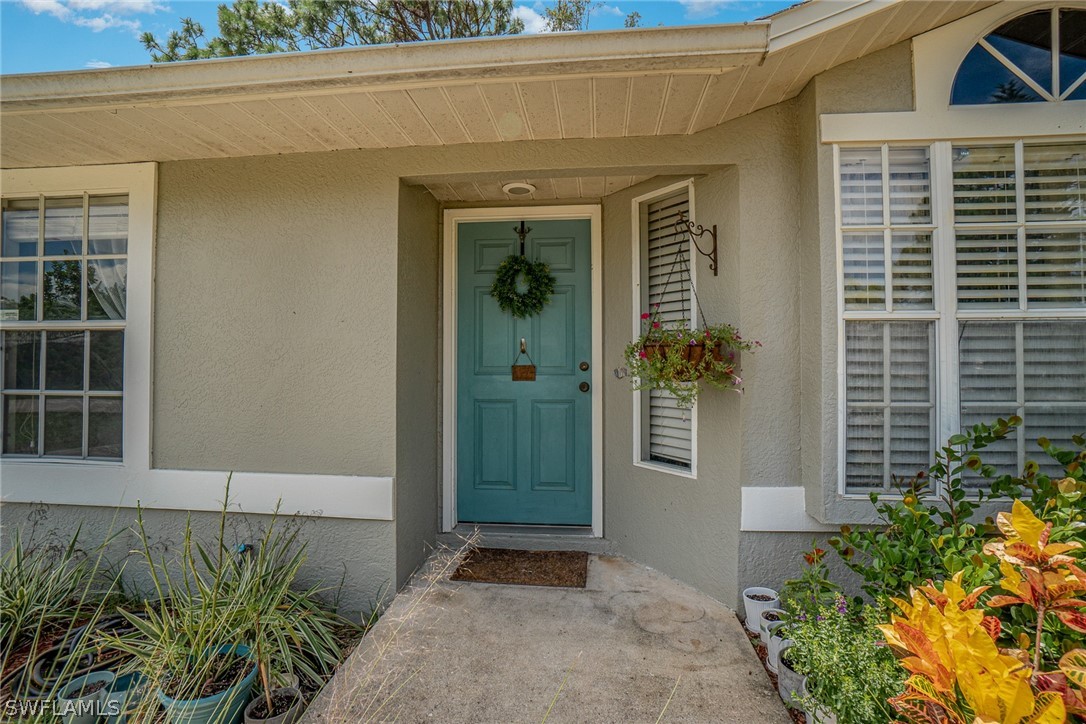 18210 Oak Road Fort Myers, FL 33967 - Photo 1 of 23 a front view of a house with a yard