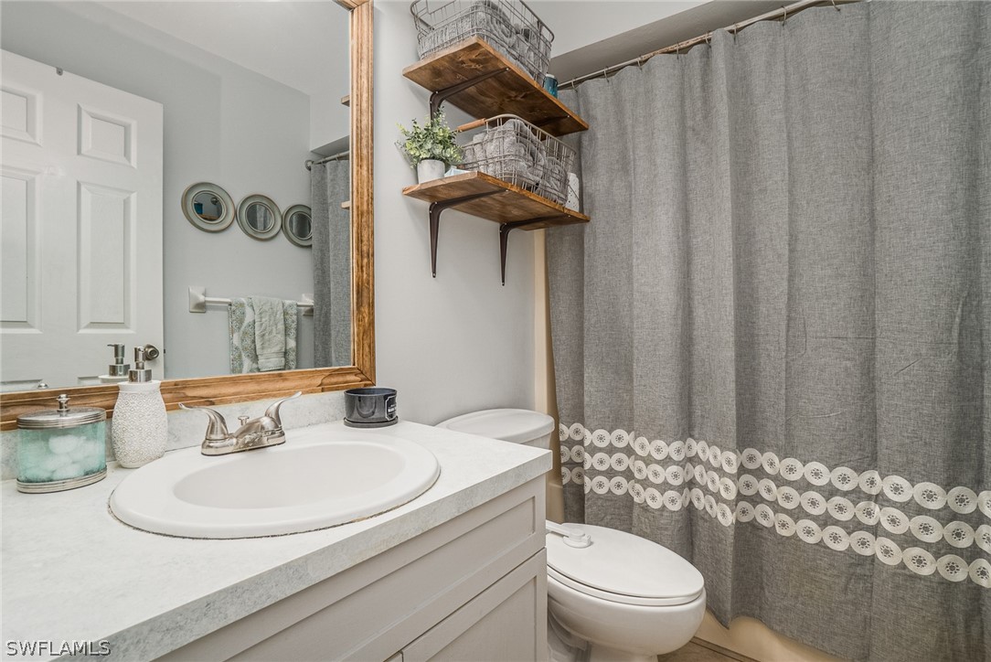 18210 Oak Road Fort Myers, FL 33967 - Photo 15 of 23 a bathroom with a sink a toilet and shower curtain