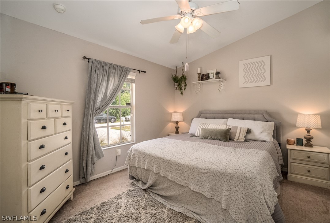 18210 Oak Road Fort Myers, FL 33967 - Photo 8 of 23 a bedroom with a large bed and a window