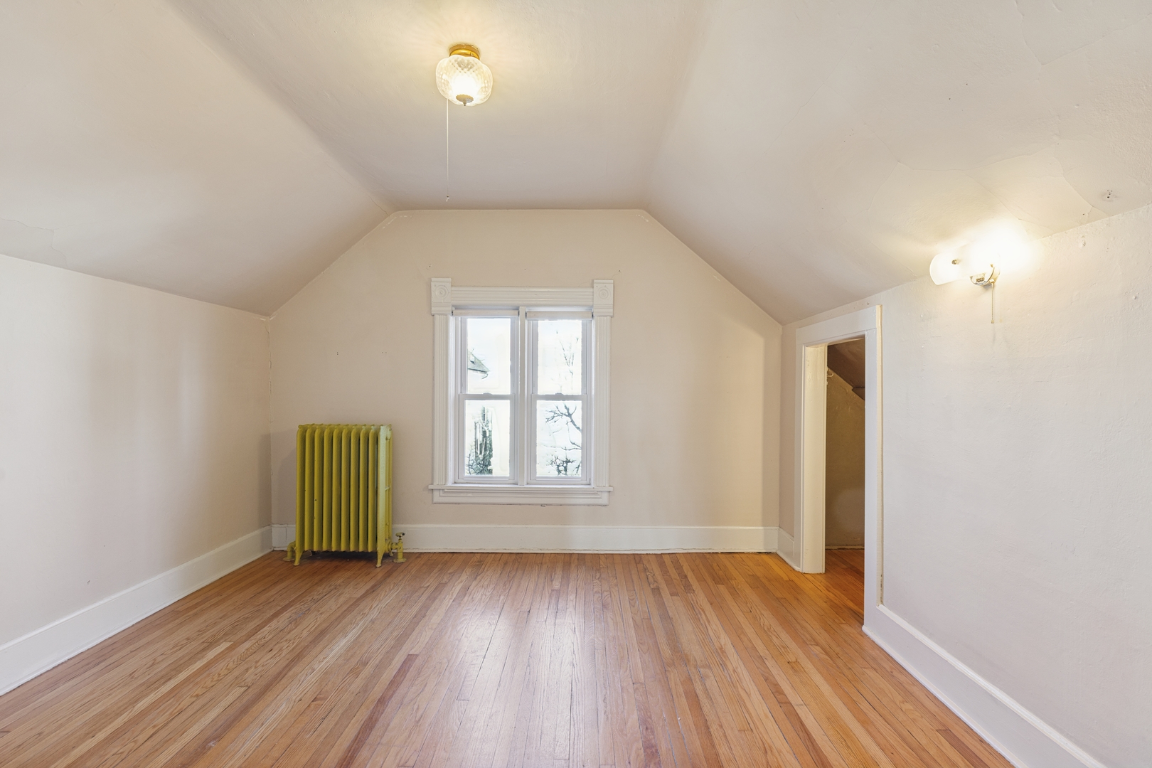 2721 West Prindiville Street Chicago, IL 60647 - Photo 8 of 16 an empty room with wooden floor and windows