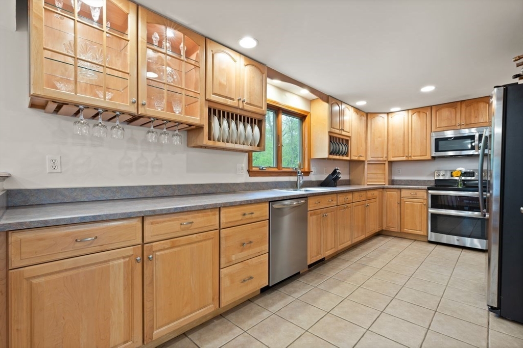 23 Gabriel Road Sharon, MA 02067 - Photo 13 of 41 a kitchen with stainless steel appliances granite countertop a sink and cabinets