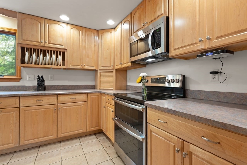 23 Gabriel Road Sharon, MA 02067 - Photo 14 of 41 a kitchen with stainless steel appliances granite countertop a sink a stove and cabinets