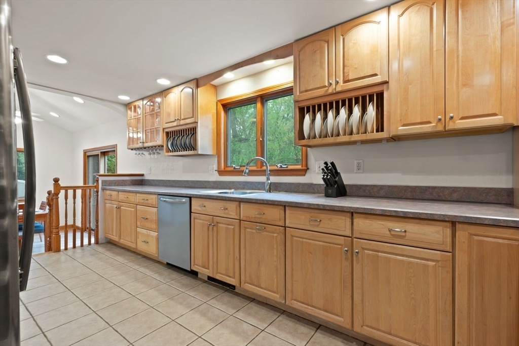 23 Gabriel Road Sharon, MA 02067 - Photo 15 of 41 a kitchen with stainless steel appliances granite countertop a stove a sink and a microwave