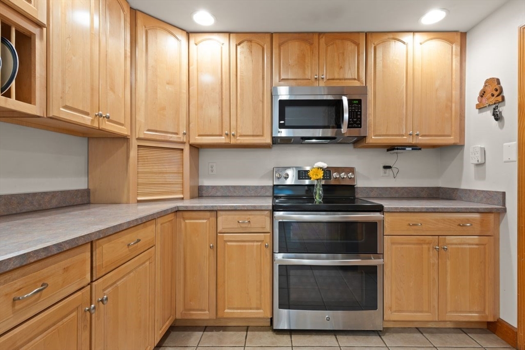 23 Gabriel Road Sharon, MA 02067 - Photo 16 of 41 a kitchen with granite countertop a stove and a microwave