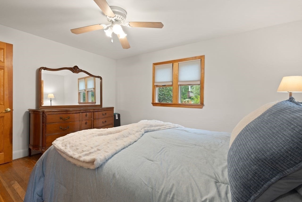 23 Gabriel Road Sharon, MA 02067 - Photo 19 of 41 a bedroom with a bed and a chandelier