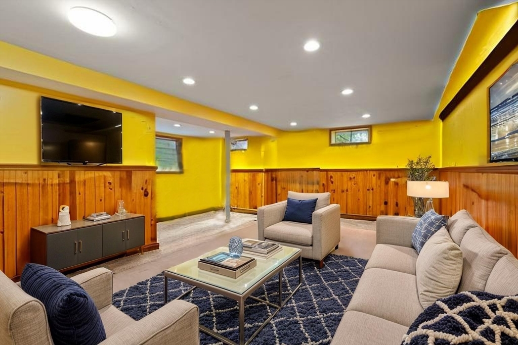 23 Gabriel Road Sharon, MA 02067 - Photo 23 of 41 a living room with furniture and a flat screen tv