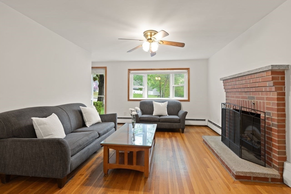 23 Gabriel Road Sharon, MA 02067 - Photo 3 of 41 a living room with furniture and a fireplace