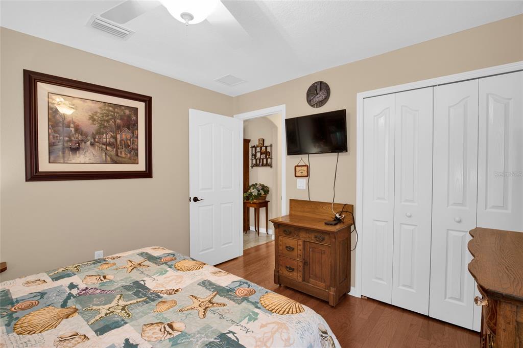 16411 Southwest 14th Avenue Road Ocala, FL 34473 - Photo 21 of 59 a bedroom with a bed and a flat screen tv