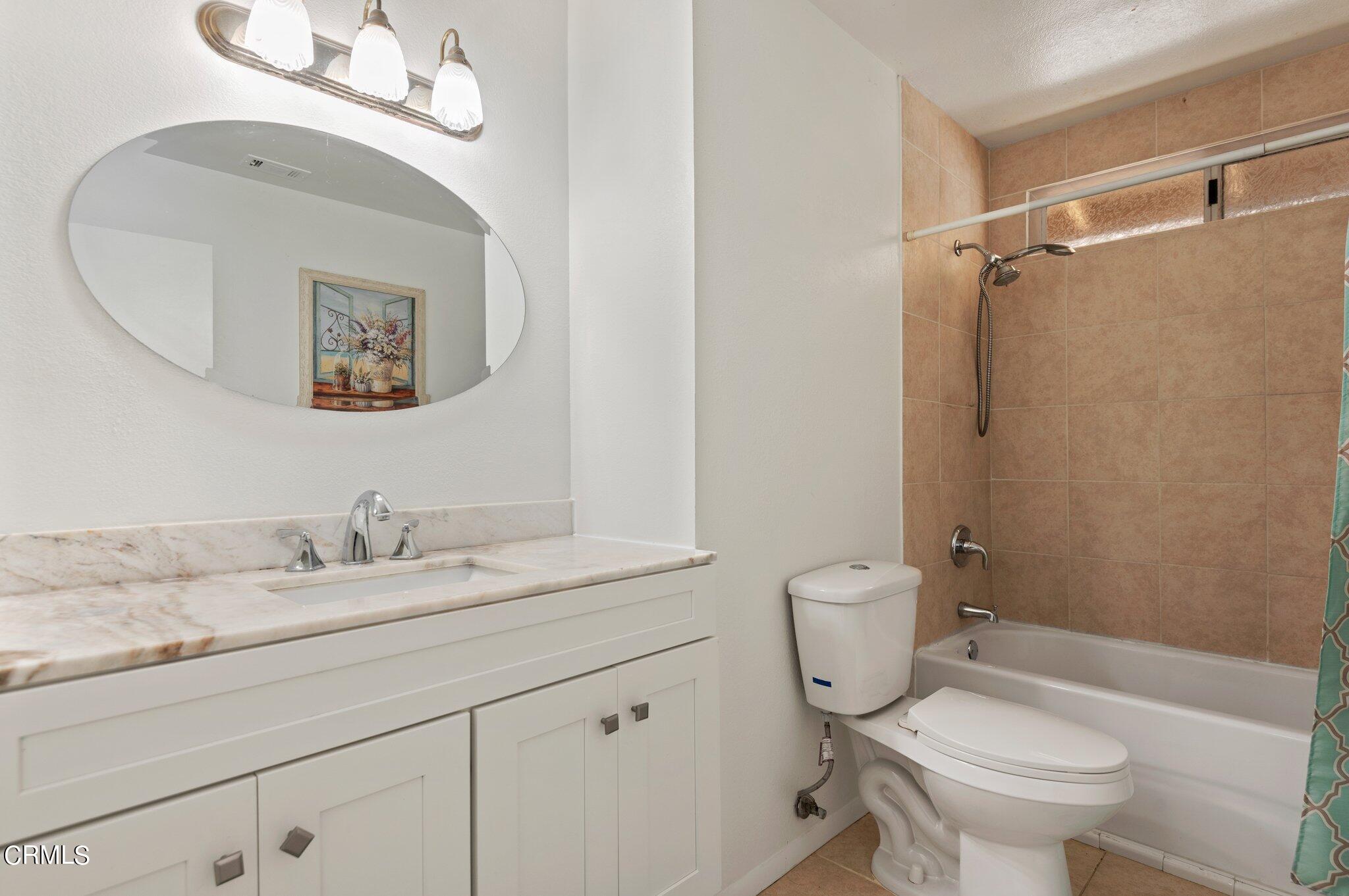 3041 Jacktar Avenue Oxnard, CA 93035 - Photo 17 of 19 a bathroom with a granite countertop toilet a sink and a mirror