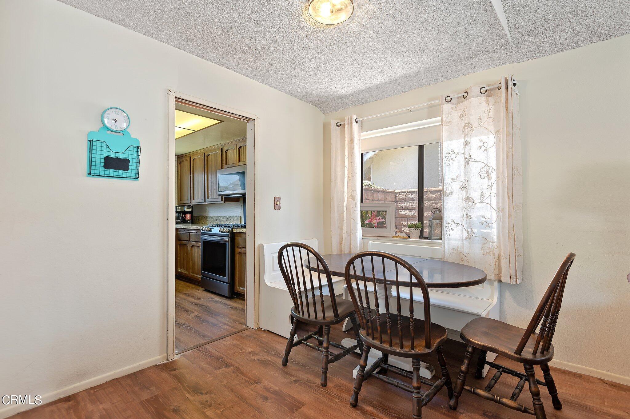 3041 Jacktar Avenue Oxnard, CA 93035 - Photo 7 of 19 a view of a dining room with furniture and a window