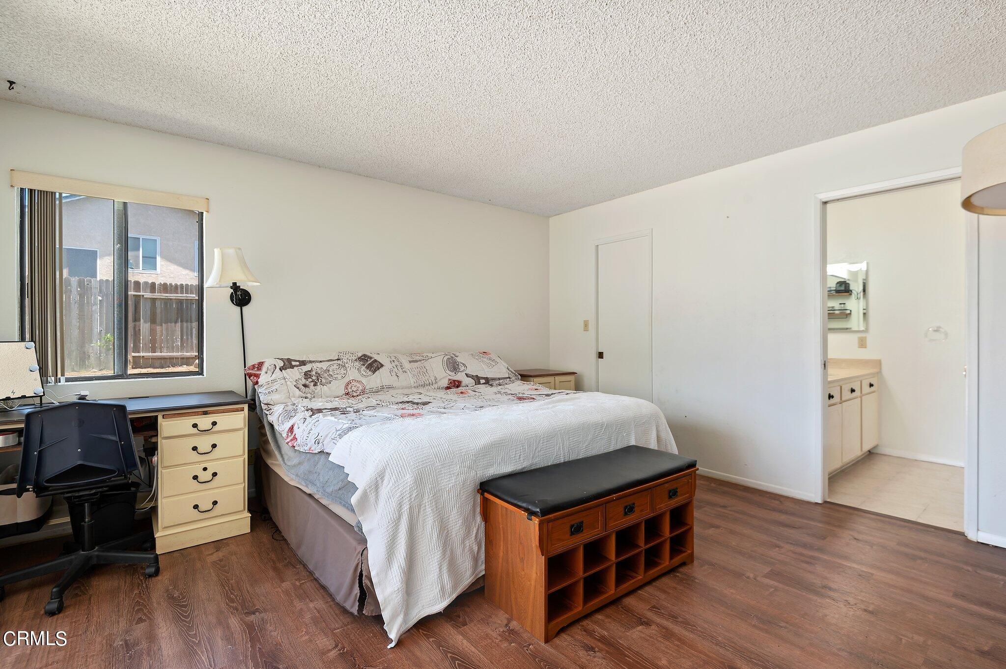 3041 Jacktar Avenue Oxnard, CA 93035 - Photo 10 of 19 a bedroom with a bed and wooden floor