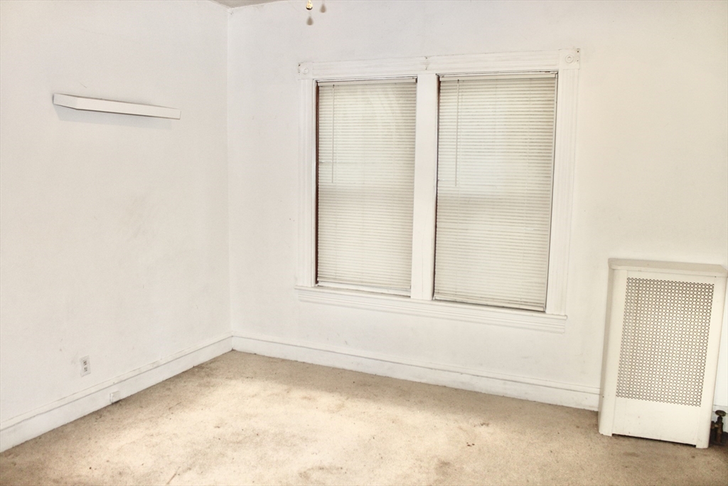 136 Horton Street, Unit 1 Fall River, MA 02723 - Photo 9 of 17 an empty room with a empty space and windows