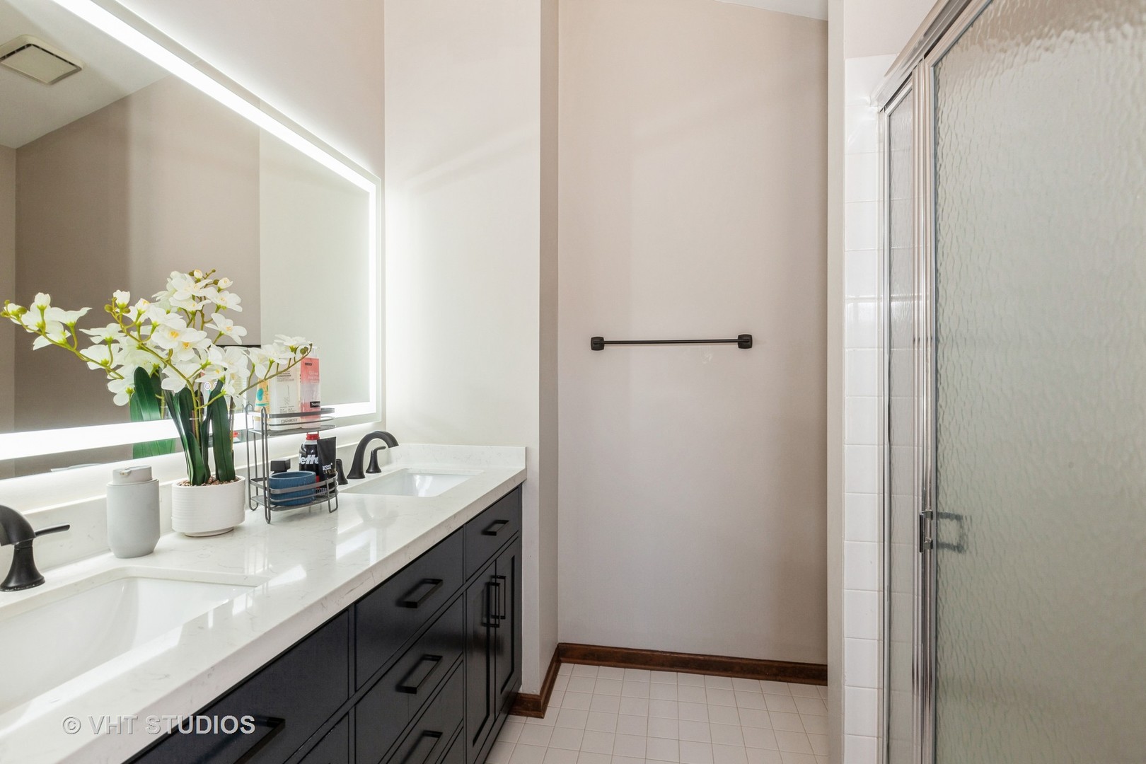 960 Heathrow Lane Naperville, IL 60540 - Photo 14 of 24 a bathroom with a granite countertop sink a mirror and a shower